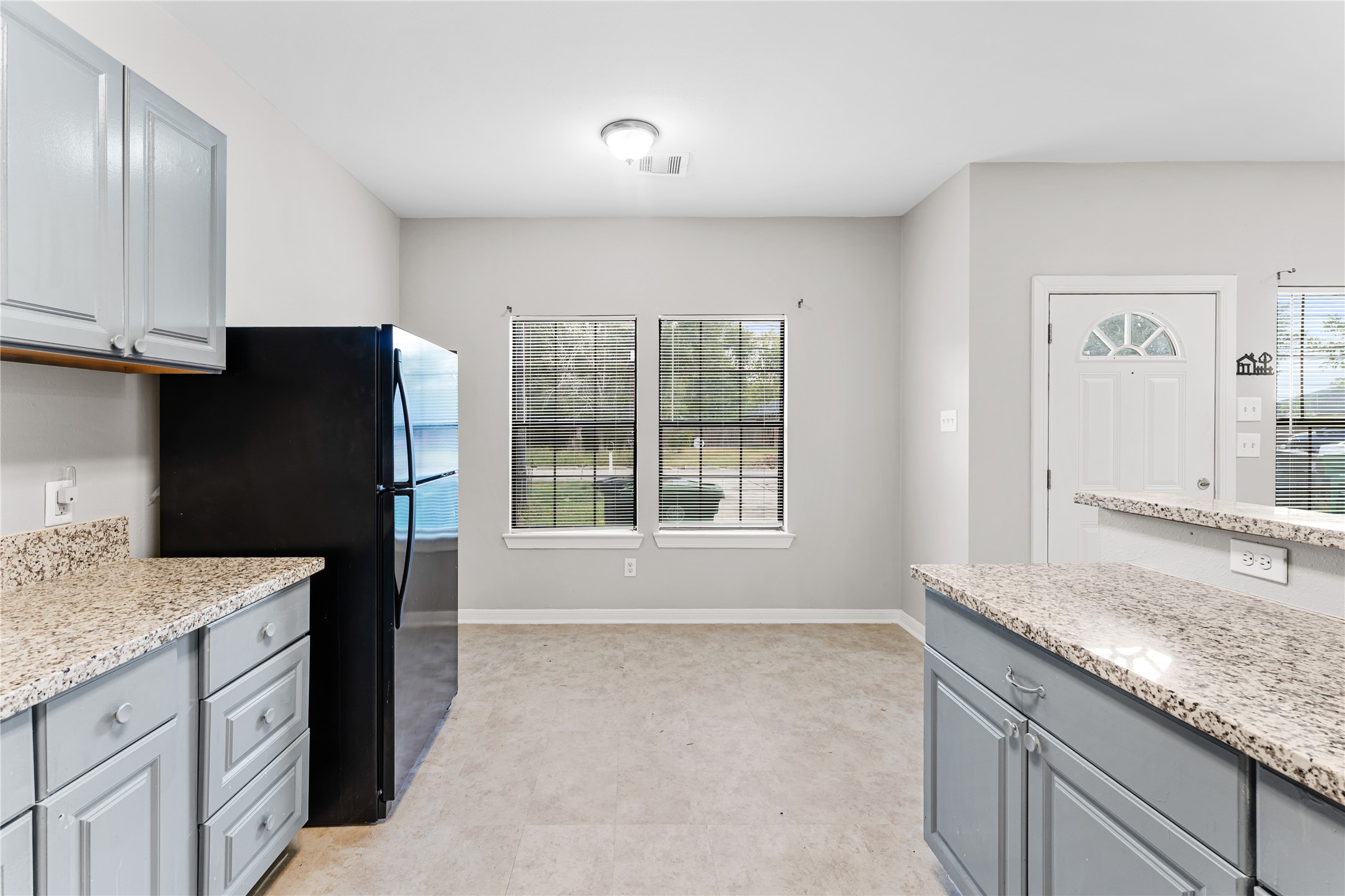 9610 Buffum Street, Unit B Houston, TX 77051 - Photo 7 of 25 a kitchen with granite countertop a refrigerator and a sink