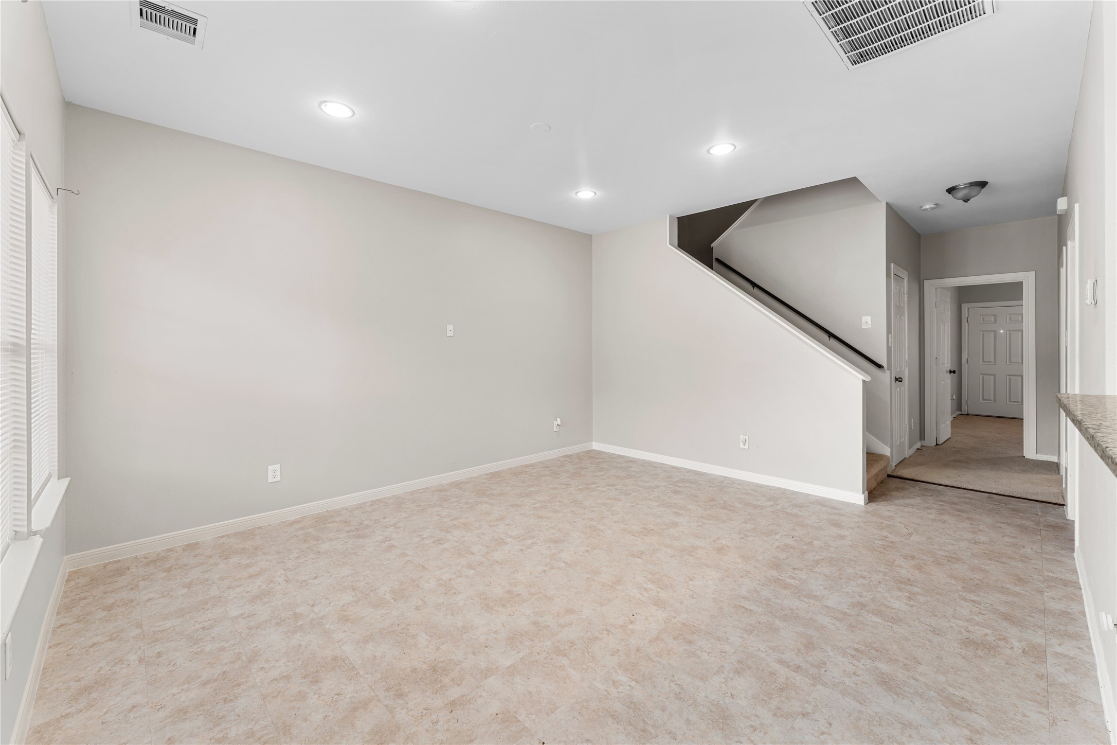 9610 Buffum Street, Unit B Houston, TX 77051 - Photo 9 of 25 an empty room with staircase and white walls