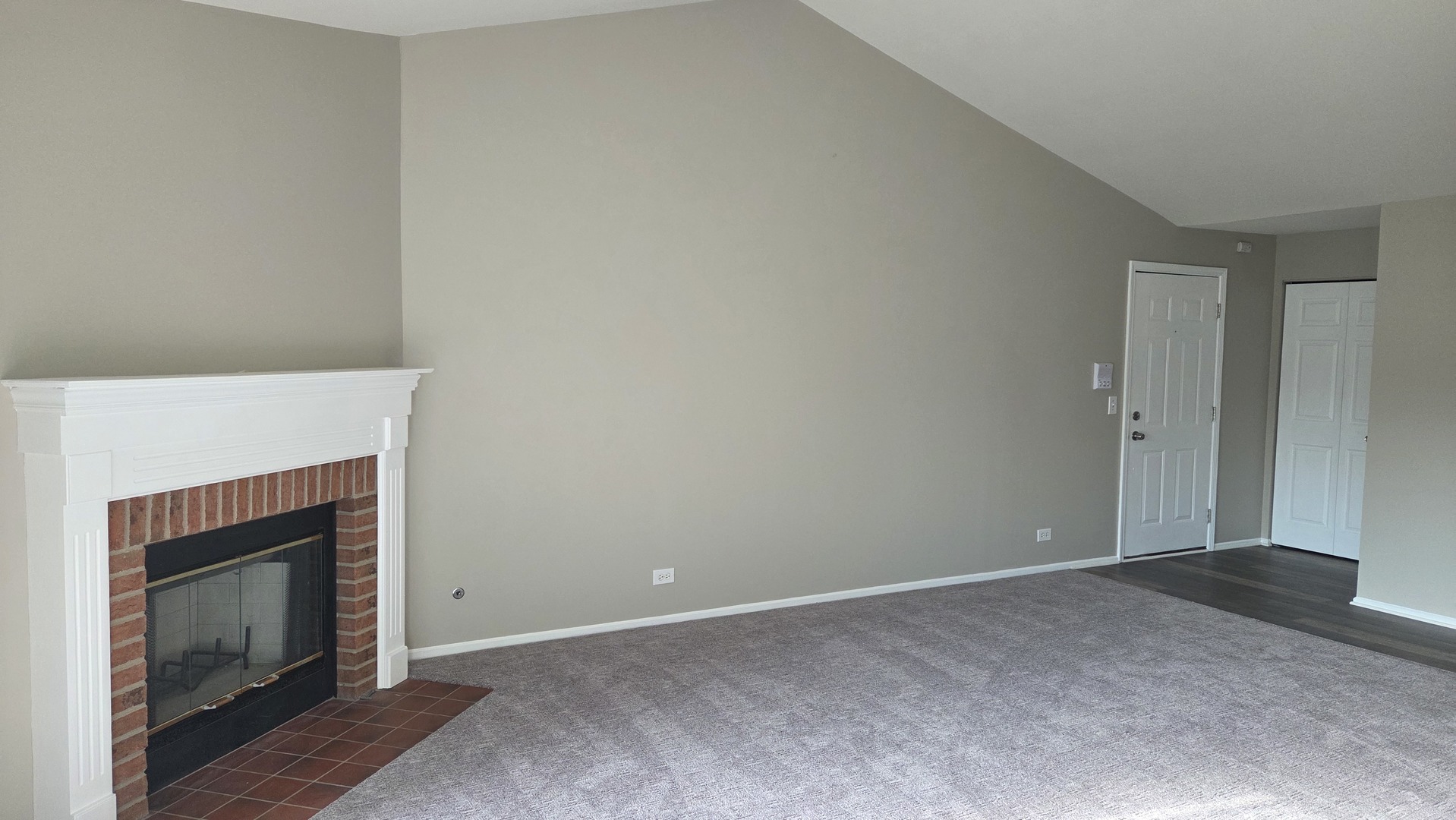 67 Beechmont Court, Unit W2 Schaumburg, IL 60193 - Photo 2 of 15 a view of empty room with a fireplace