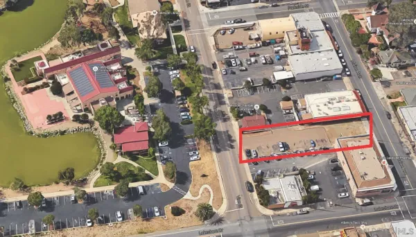 an aerial view of multi story residential apartment building with yard