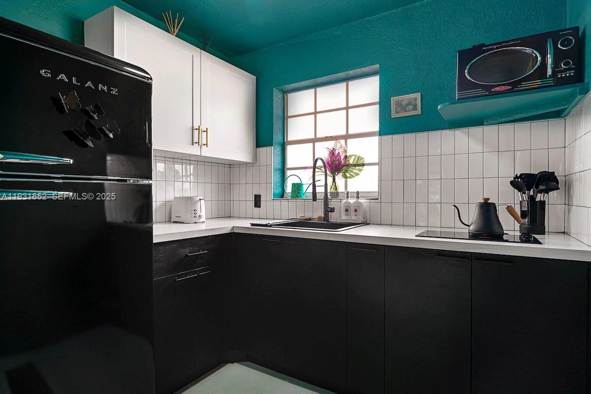 1007 Southeast 2nd Court, Unit 4 Fort Lauderdale, FL 33301 - Photo 13 of 15 a kitchen with a sink and cabinets