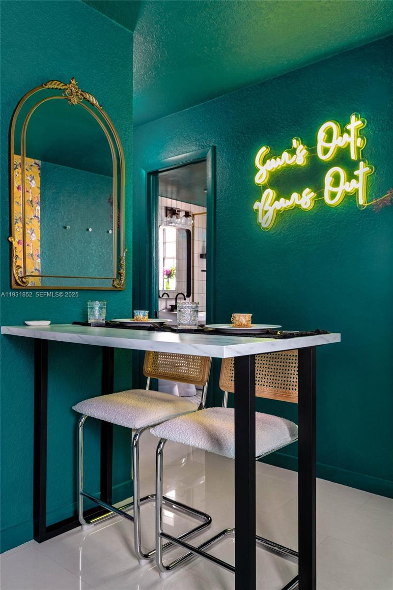 1007 Southeast 2nd Court, Unit 4 Fort Lauderdale, FL 33301 - Photo 10 of 15 a kitchen with a table and chairs in it