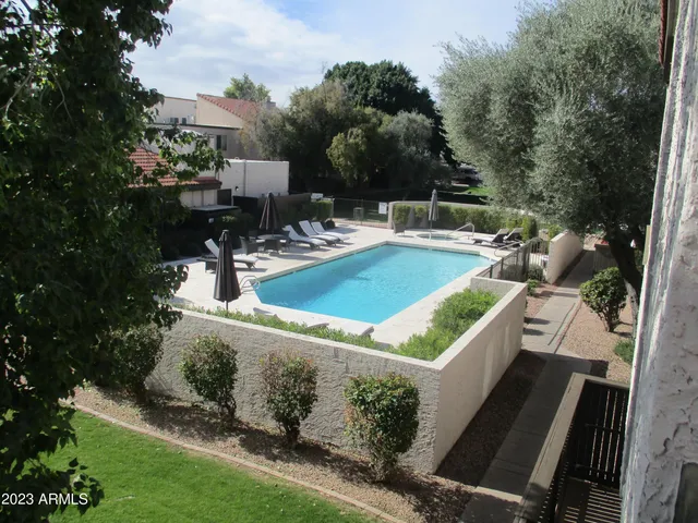a view of a patio with table and chairs and potted plants