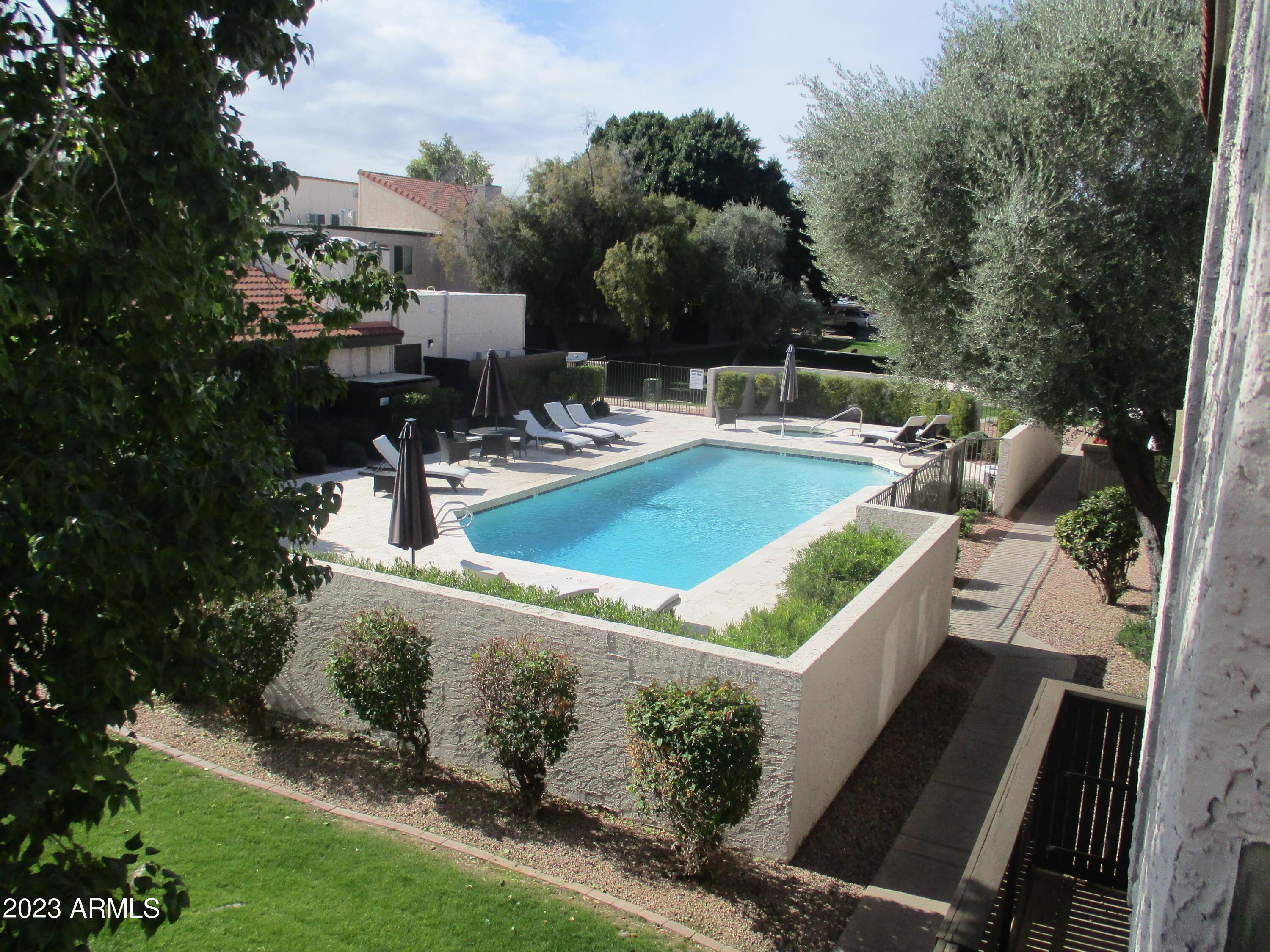 a view of a patio with table and chairs and potted plants
