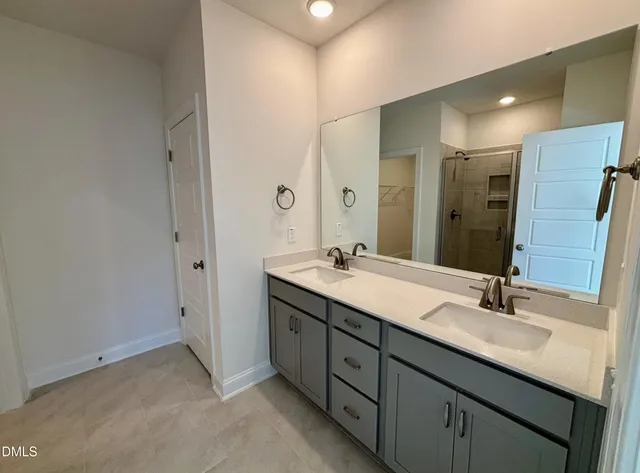 a bathroom with a double vanity sink and a mirror