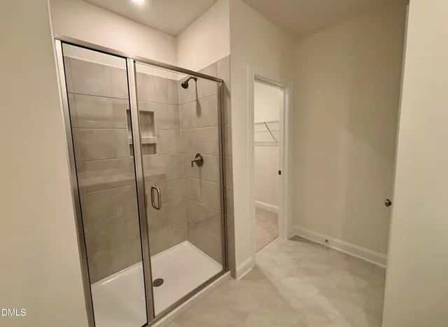 a bathroom with a glass shower door
