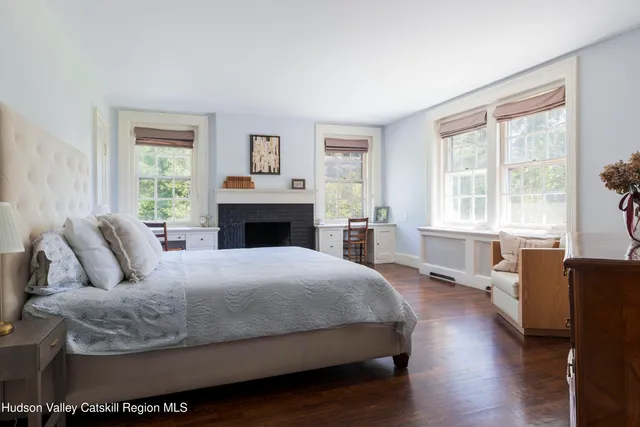 a bathroom with a granite countertop sink a mirror and shower