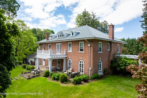 a front view of house with yard and green space