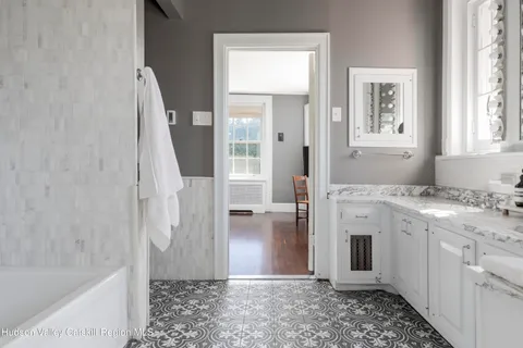 a bathroom with a granite countertop sink a toilet and shower