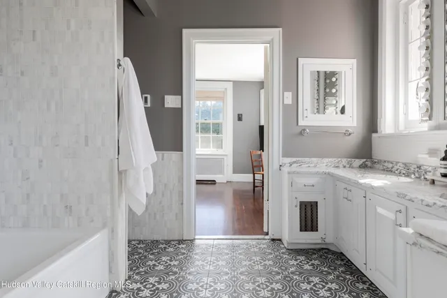 a bathroom with a granite countertop sink a toilet and shower
