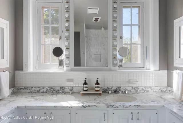 a bedroom with two beds and wooden floor