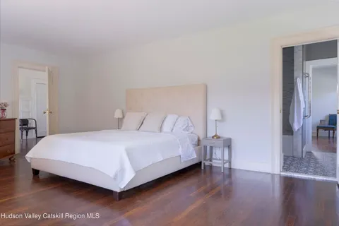 a bedroom with a bed and a large window