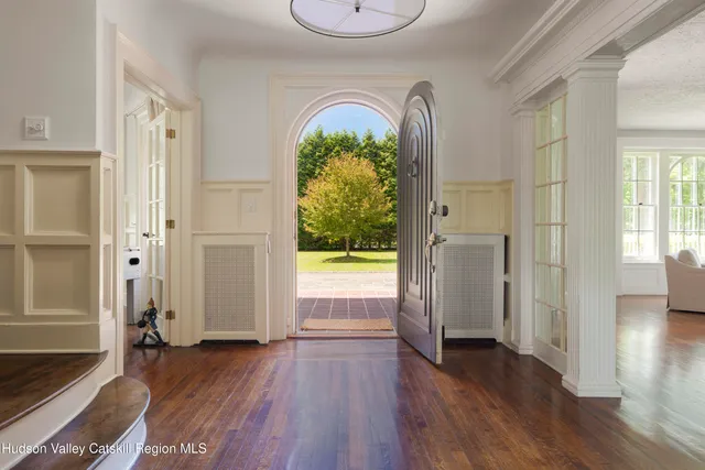 a view of a swimming pool with a bench and trees