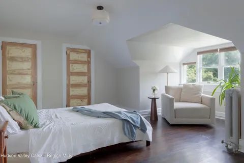 a bedroom with a bed and a potted plant