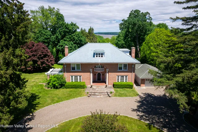 a front view of house with yard and green space