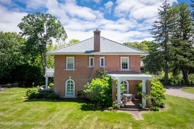 a view of a swimming pool with a table and chairs in patio