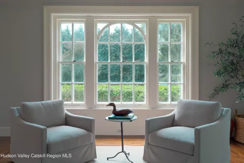a view of a brick house with a fountain and a potted plant
