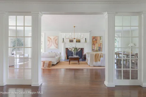 a living room with furniture a fireplace and a large window