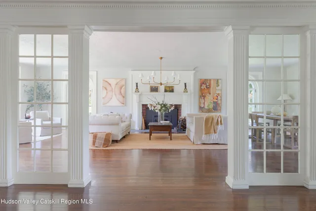 a living room with furniture a fireplace and a large window