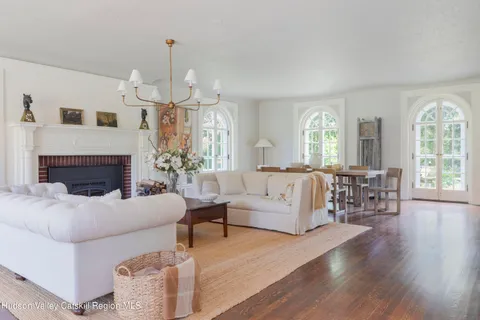 a living room with furniture and a chandelier