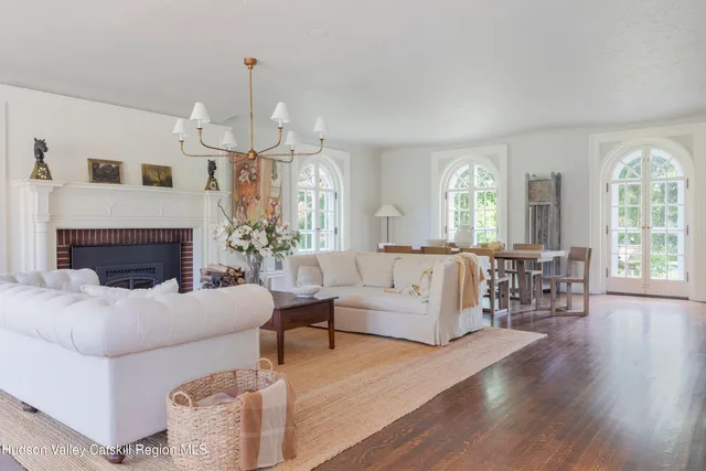 a living room with furniture and a chandelier