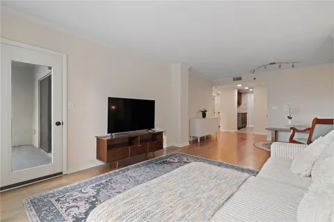 a living room with furniture and a wooden floor