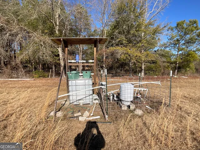 a view of a patio with table and chairs with wooden floor and fence