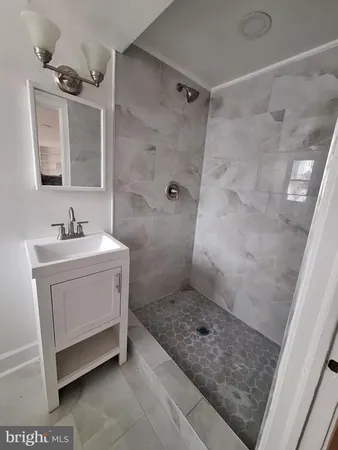 a bathroom with a sink a mirror and a shower