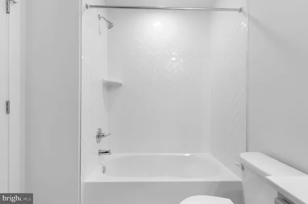 a bathroom with a bathtub and a toilet