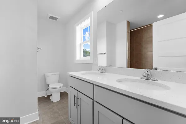 a bathroom with a sink toilet and mirror