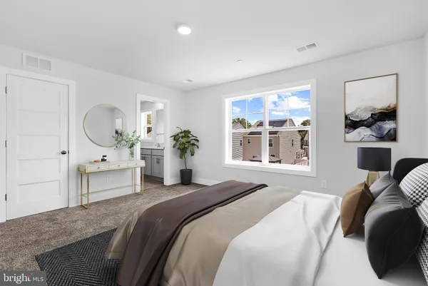 a bedroom with a bed a mirror and windows