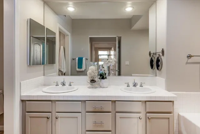 a bathroom with a sink vanity and a mirror