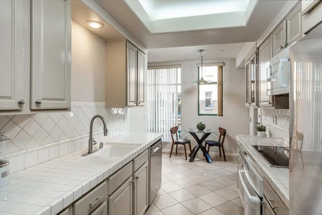 a kitchen with cabinets a sink and appliances