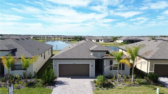 a aerial view of a house with a yard potted plants and a large tree