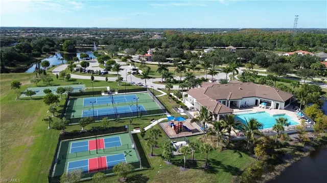 an aerial view of multiple houses with yard