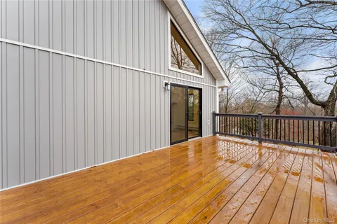 a view of backyard with wooden floor and fence