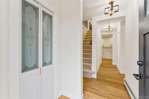 a view of a hallway with wooden floor and staircase