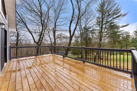 a view of balcony with wooden floor and fence