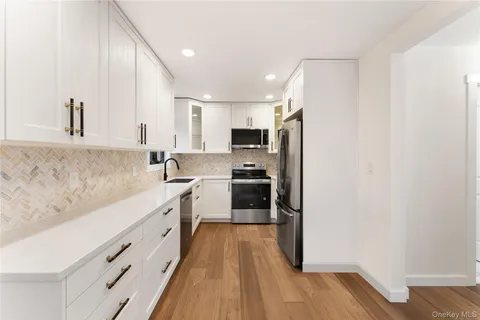 a kitchen with stainless steel appliances a refrigerator sink and cabinets