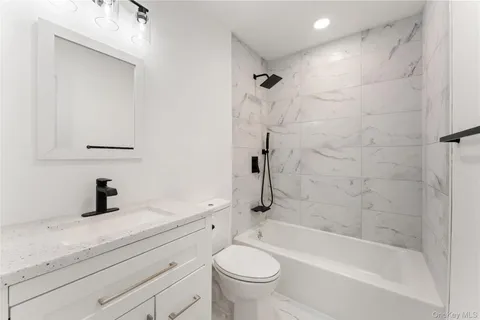 a bathroom with a sink a toilet and a bathtub