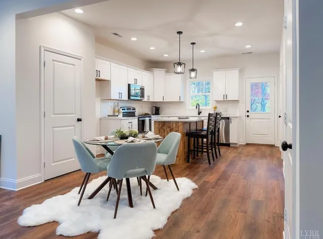 a view of a dining room with furniture and wooden floor