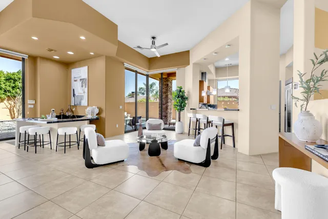 a dining room with furniture and potted plant