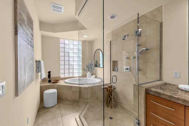 a bedroom with a bed and a potted plant