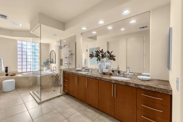 a kitchen with stainless steel appliances granite countertop a sink and a refrigerator