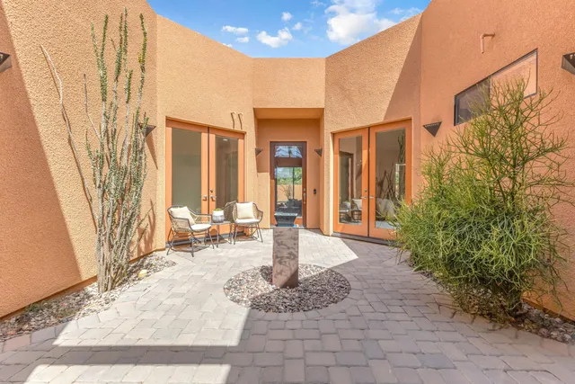a kitchen with stainless steel appliances granite countertop a sink and a refrigerator
