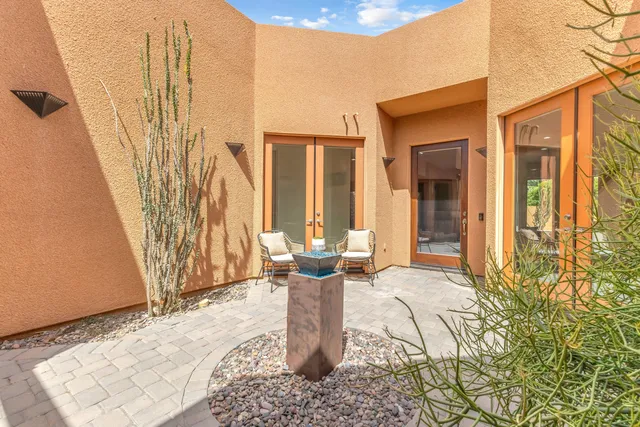 a living room with furniture and a floor to ceiling window