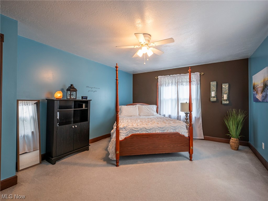 9452 Pleasant Hill Road Northwest Dundee, OH 44624 - Photo 23 of 35 Carpeted bedroom with a textured ceiling and ceiling fan