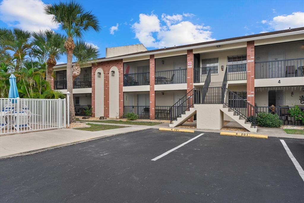 1531 Placida Road, Unit 204 Englewood, FL 34223 - Photo 1 of 47 a view of a house with a patio and a yard