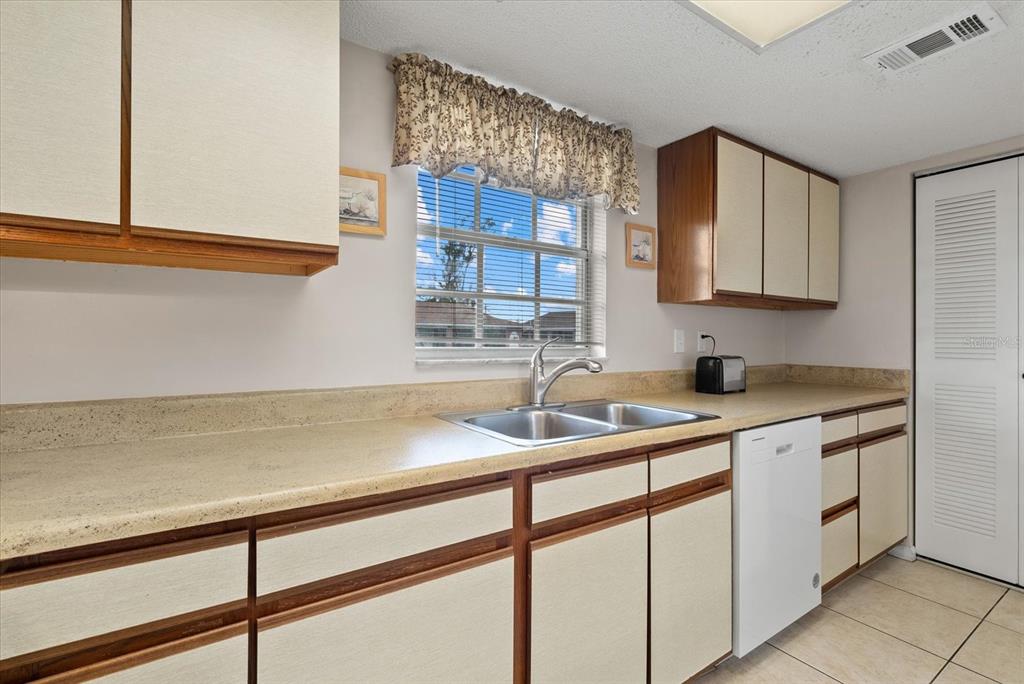 1531 Placida Road, Unit 204 Englewood, FL 34223 - Photo 13 of 47 a kitchen with a sink and cabinets