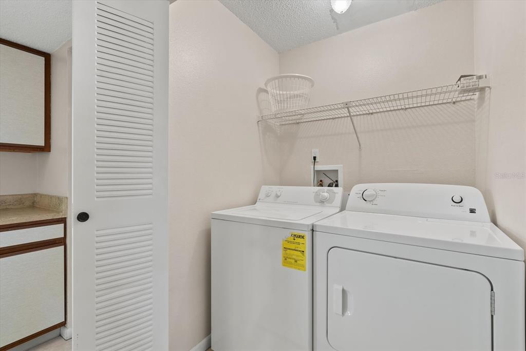 1531 Placida Road, Unit 204 Englewood, FL 34223 - Photo 15 of 47 a utility room with dryer and washer